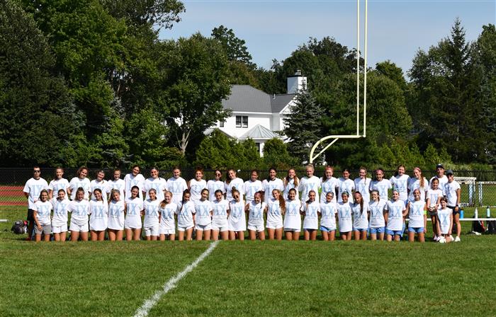Group picture of two soccer teams wearing Title IX t-shirts